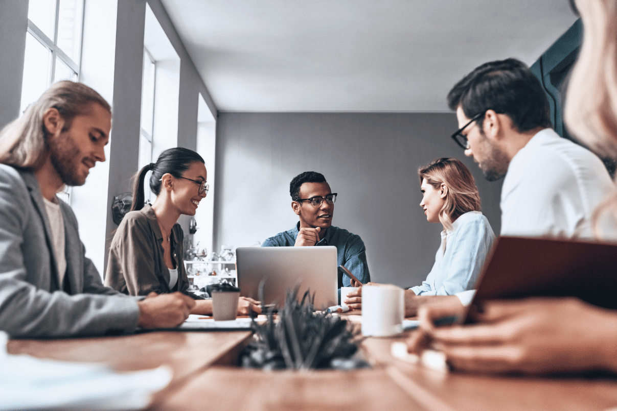 GettyImages-1066557736 Office meeting with diverse group discussing strategy.