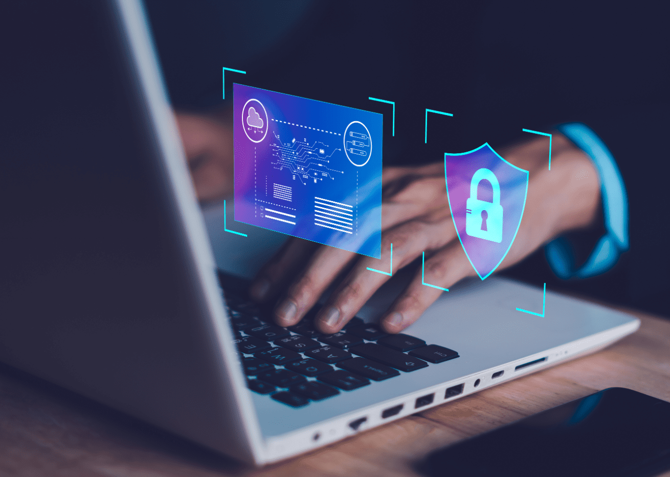 Hands typing on laptop with security icons.