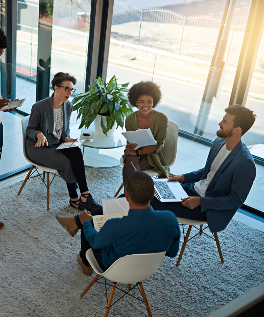 Group meeting in modern office with laptops.